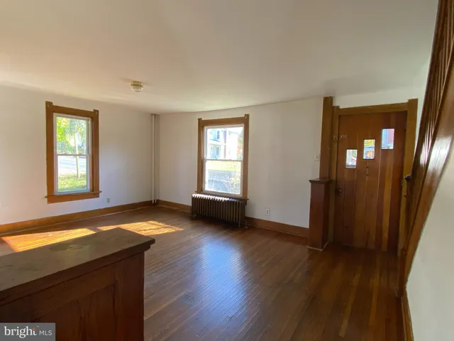 a view of a livingroom with wooden floor and a window