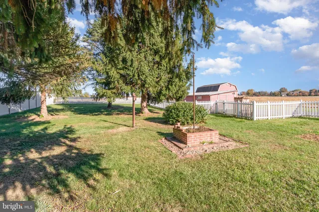 a backyard of a house with a yard and outdoor seating