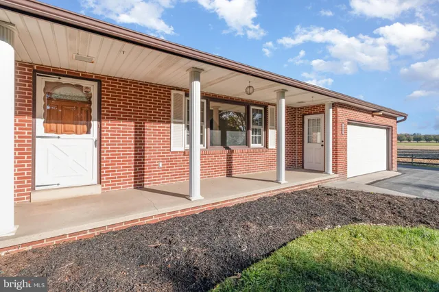 a front view of a house with a big yard and garage