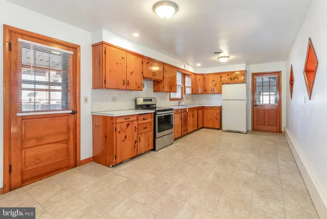 a kitchen with stainless steel appliances granite countertop a stove sink and cabinets