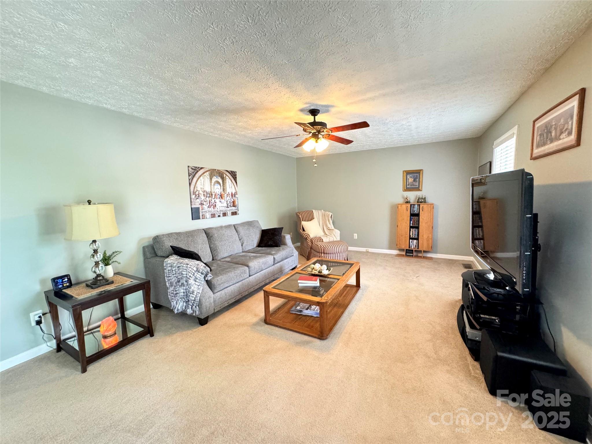 5006 Howell School Road Jonesville, NC 28642 - Photo 14 of 47 a living room with furniture and a flat screen tv