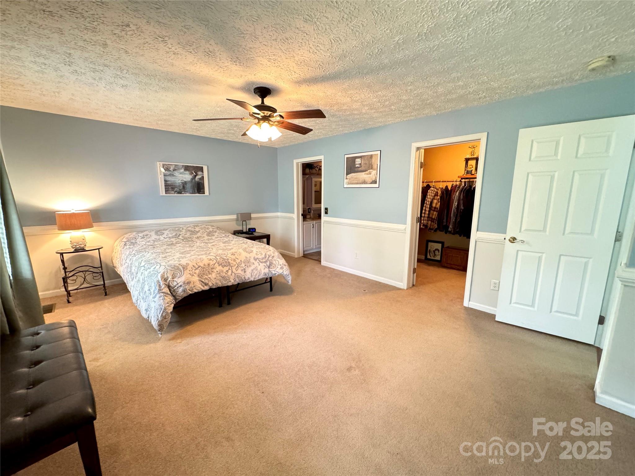 5006 Howell School Road Jonesville, NC 28642 - Photo 16 of 47 a spacious bedroom with a bed and a walk in closet