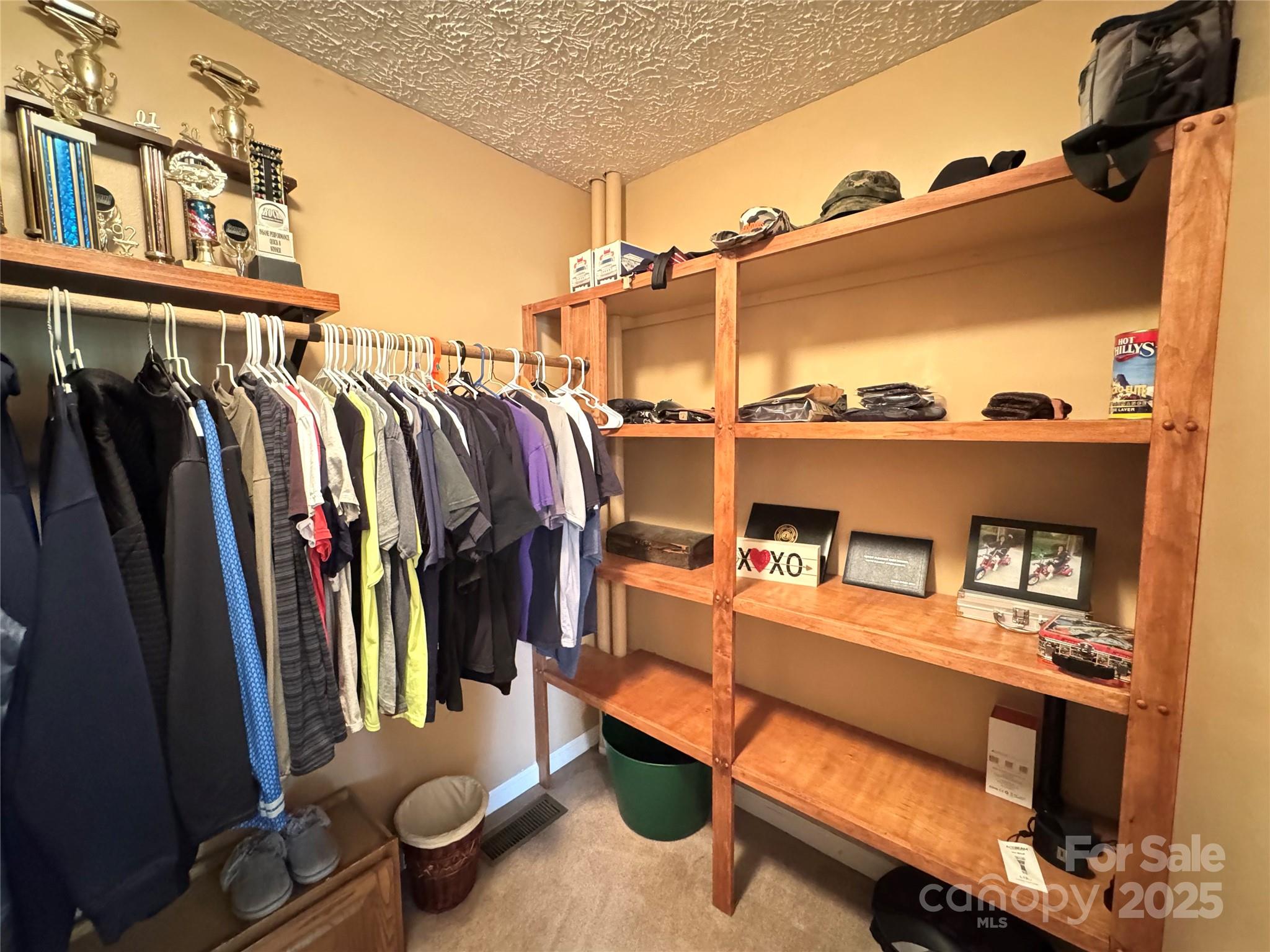 5006 Howell School Road Jonesville, NC 28642 - Photo 18 of 47 a view of walk in closet with clothes and shoes