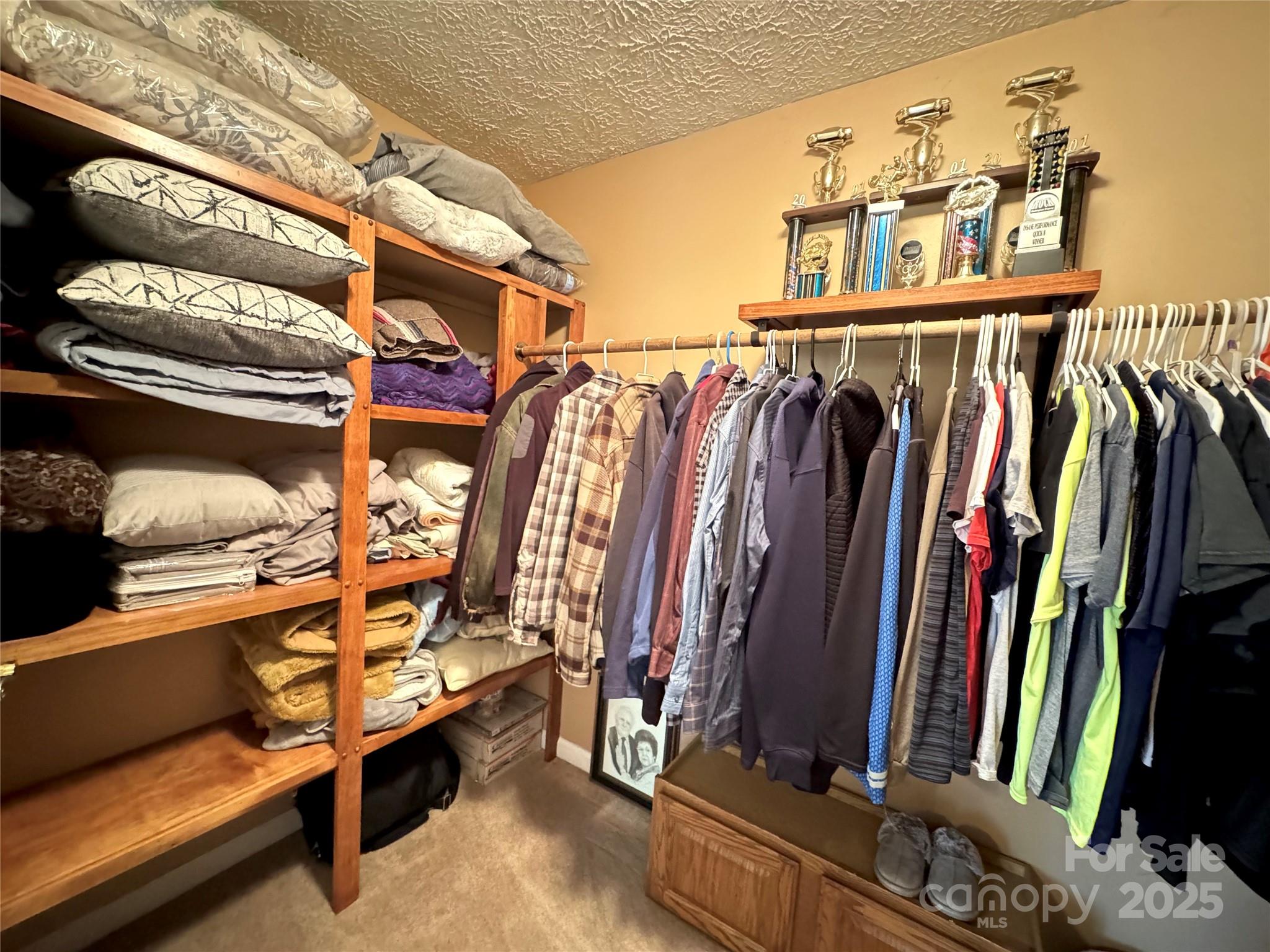 5006 Howell School Road Jonesville, NC 28642 - Photo 19 of 47 a view of walk in closet with clothes and shoes