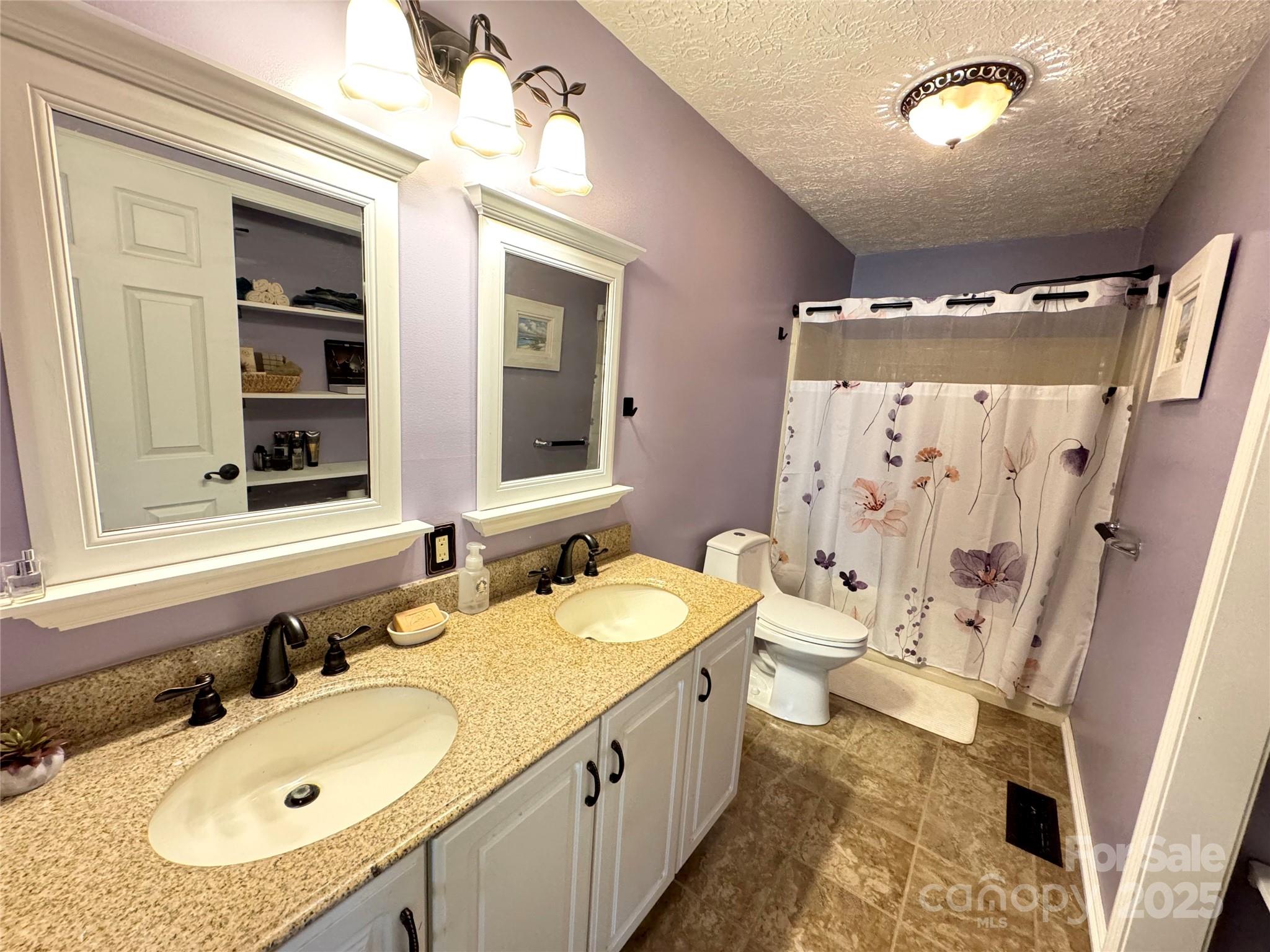 5006 Howell School Road Jonesville, NC 28642 - Photo 20 of 47 a bathroom with a sink double vanity and a mirror