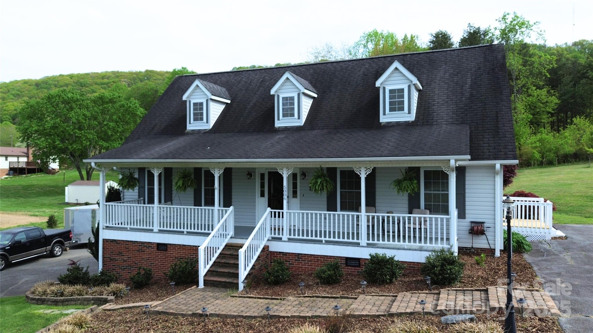 5006 Howell School Road Jonesville, NC 28642 - Photo 2 of 47 an outdoor view of a house with backyard and plants