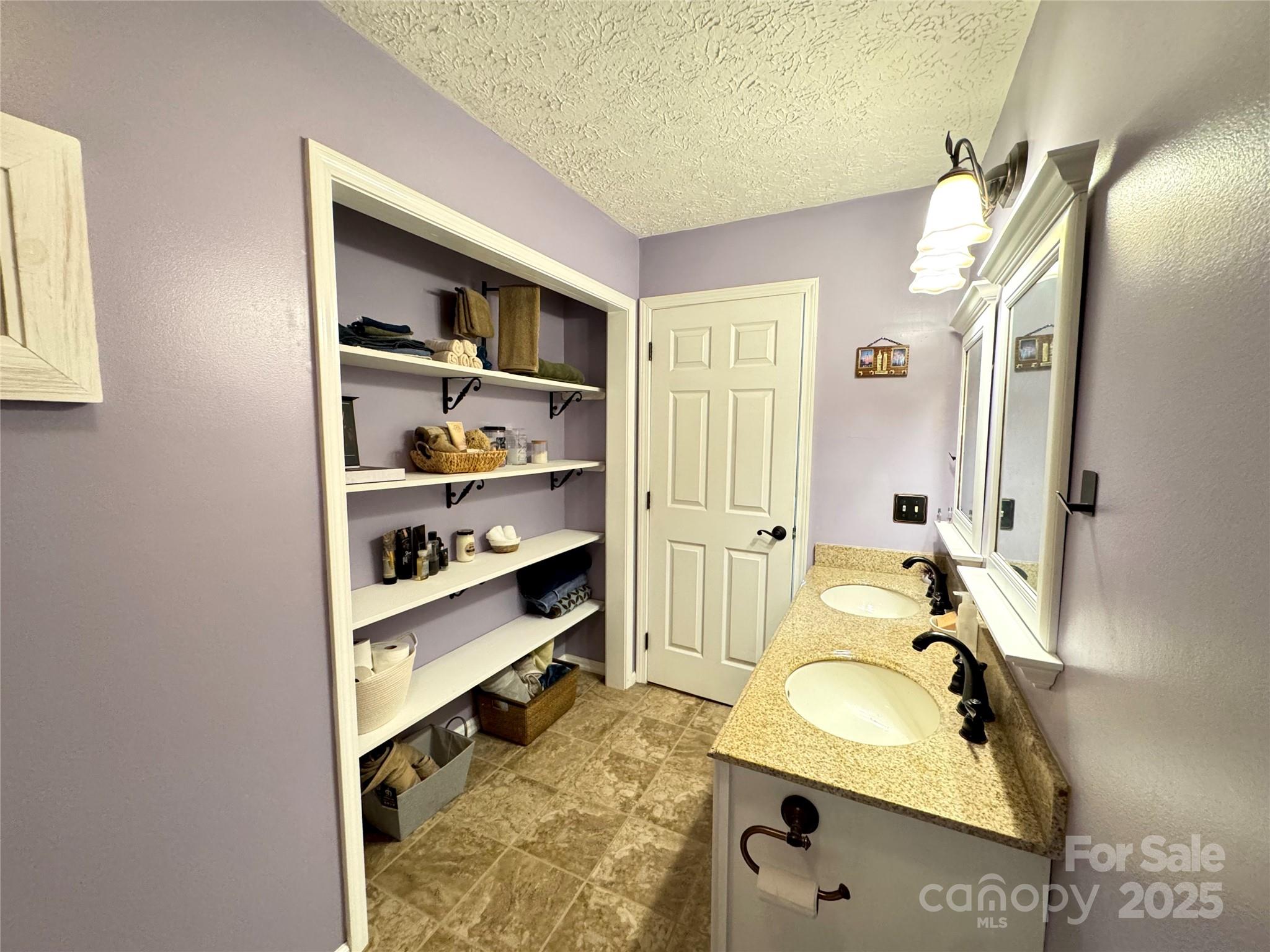 5006 Howell School Road Jonesville, NC 28642 - Photo 21 of 47 a bathroom with sink granite and a mirror