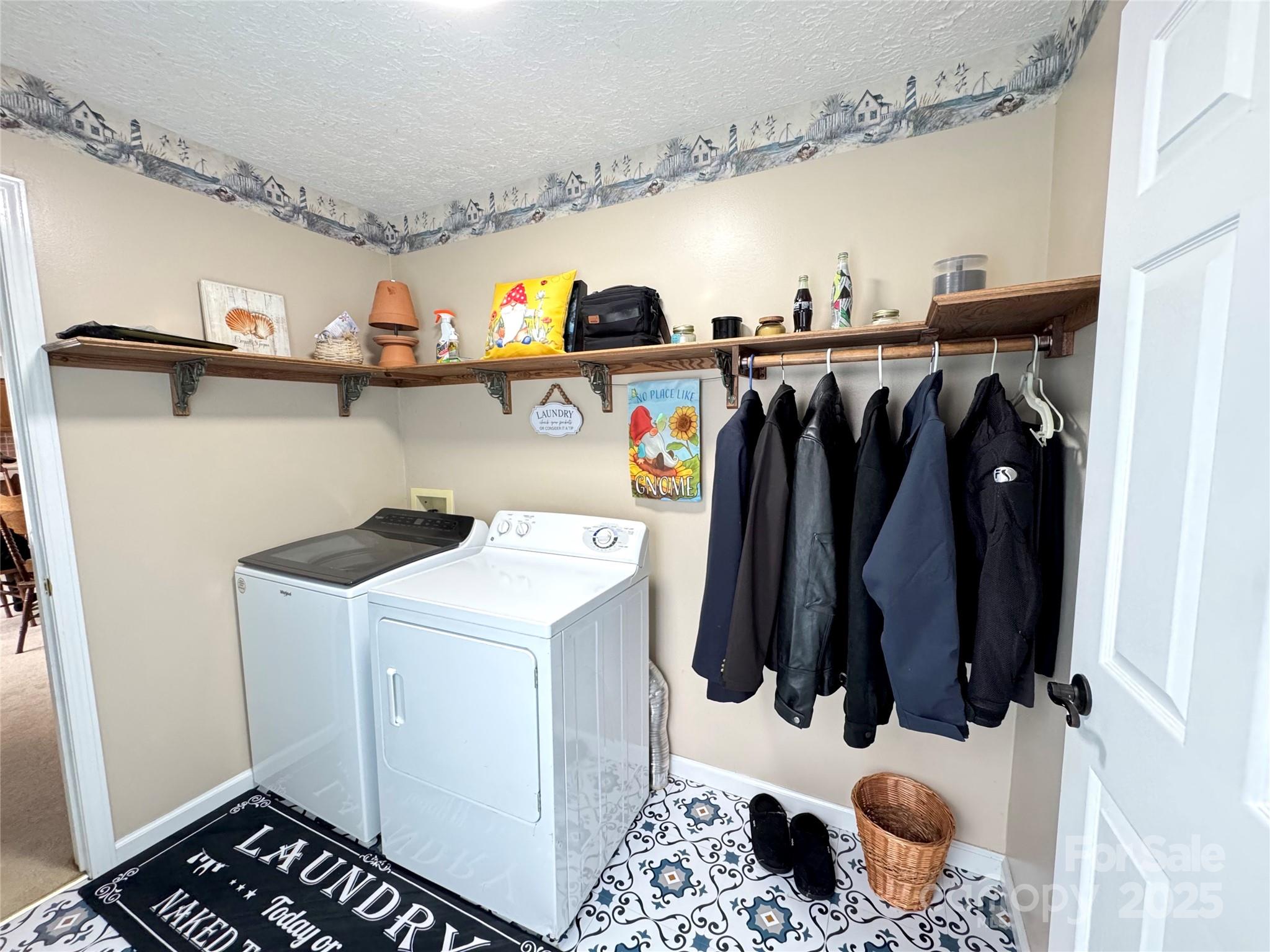 5006 Howell School Road Jonesville, NC 28642 - Photo 26 of 47 a view of walk in closet with clothes and shoes