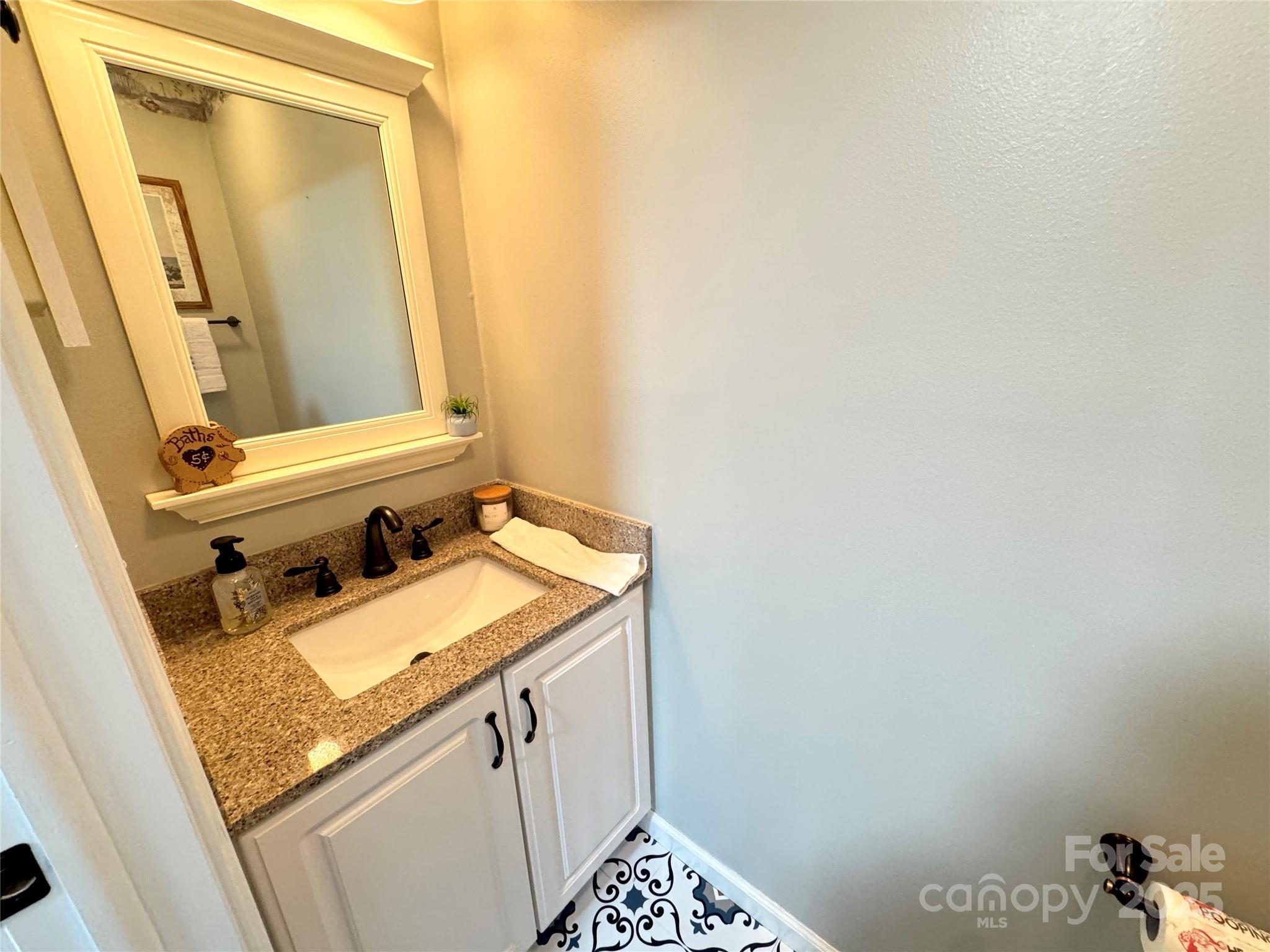 5006 Howell School Road Jonesville, NC 28642 - Photo 28 of 47 a bathroom with a sink and a mirror