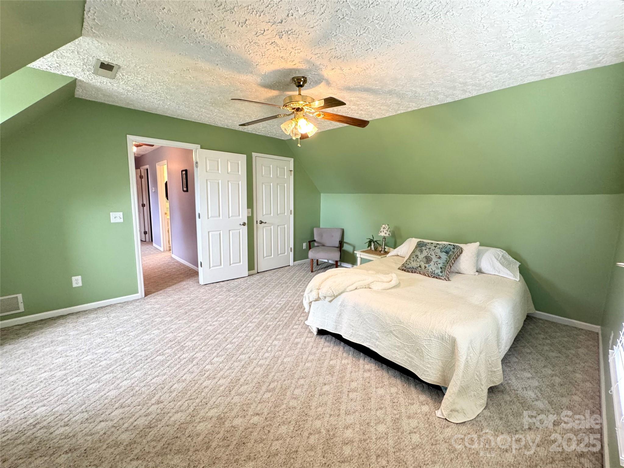 5006 Howell School Road Jonesville, NC 28642 - Photo 31 of 47 a bedroom with a bed and a chandelier
