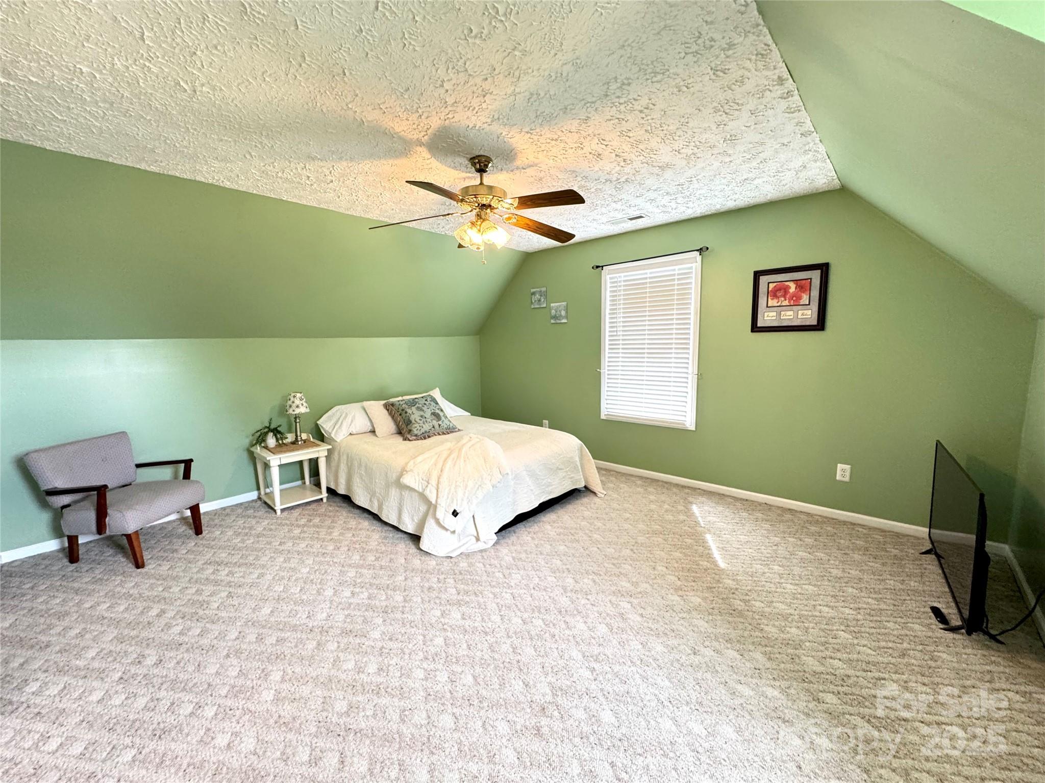 5006 Howell School Road Jonesville, NC 28642 - Photo 32 of 47 a bedroom with a bed and a chandelier
