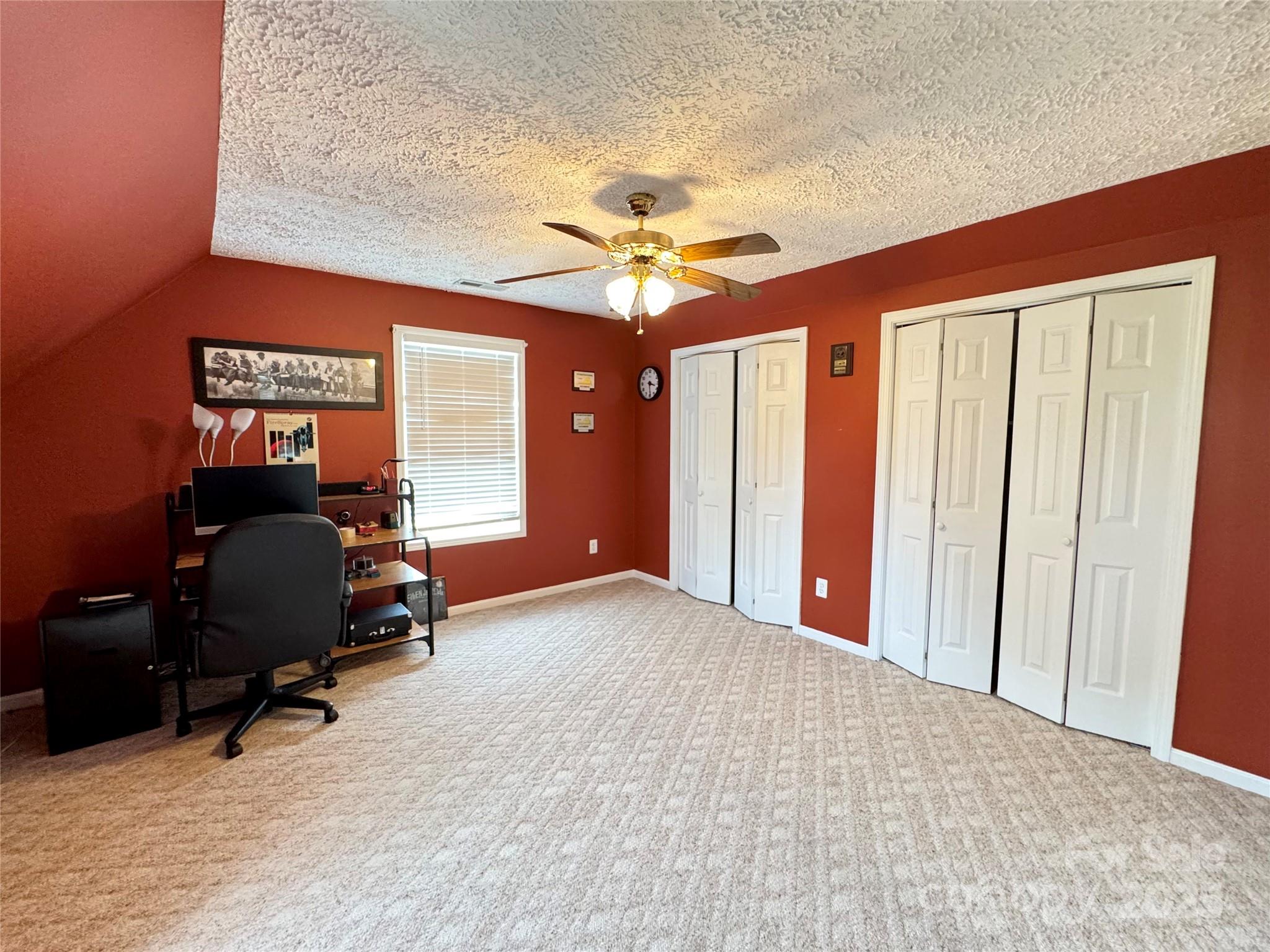 5006 Howell School Road Jonesville, NC 28642 - Photo 37 of 47 a view of a workspace with furniture and a ceiling fan
