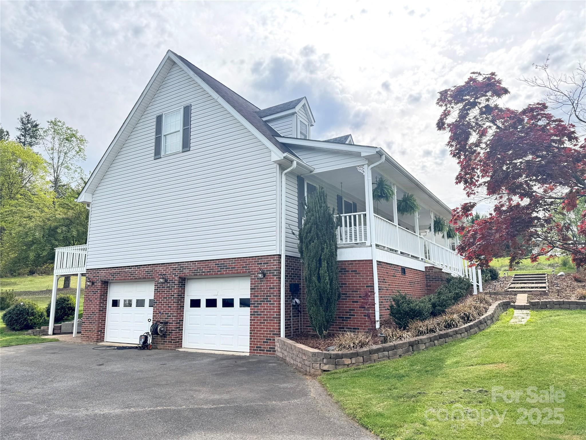 5006 Howell School Road Jonesville, NC 28642 - Photo 42 of 47 a front view of a house with a yard and garage