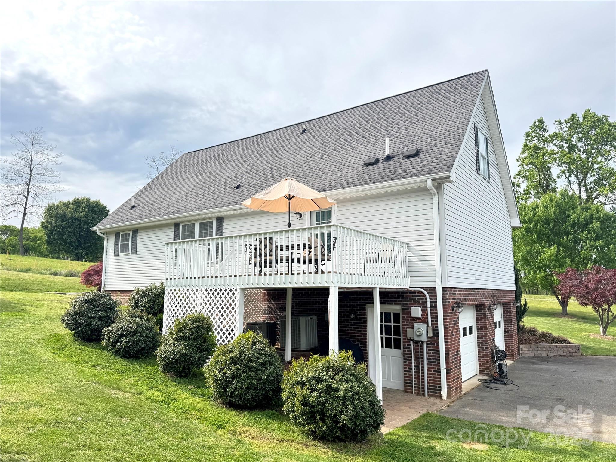 5006 Howell School Road Jonesville, NC 28642 - Photo 43 of 47 a view of a house with garden and plants