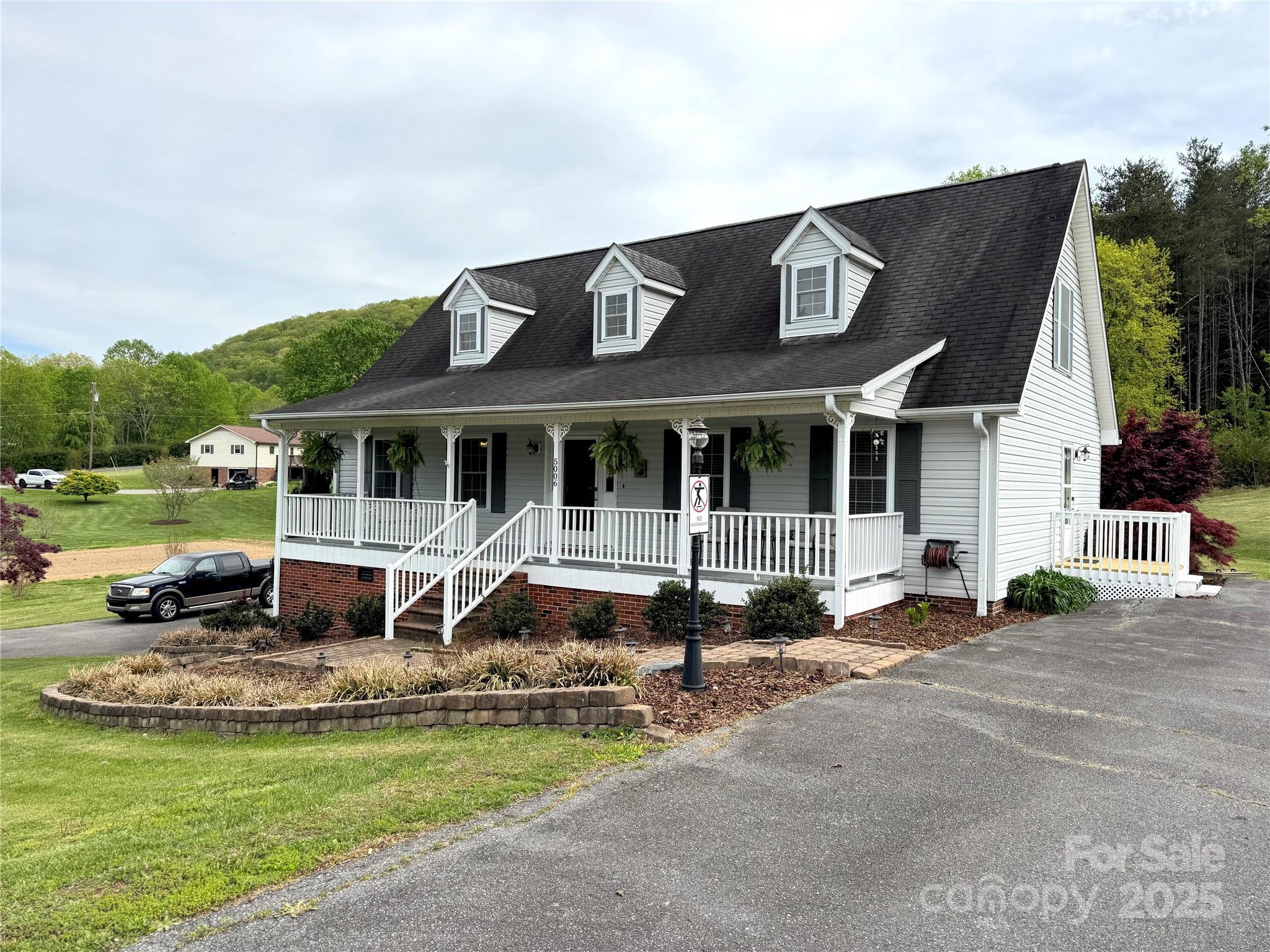 5006 Howell School Road Jonesville, NC 28642 - Photo 8 of 47 a front view of a house with a yard table and chairs