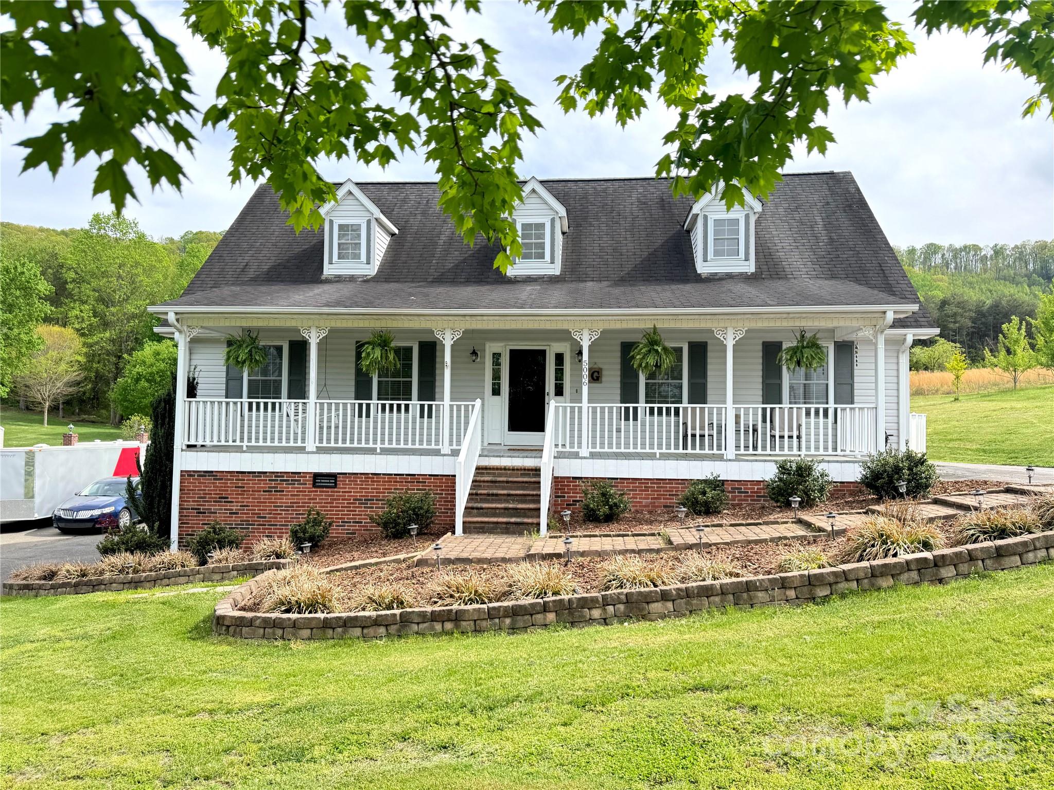 5006 Howell School Road Jonesville, NC 28642 - Photo 9 of 47 a front view of a house with a yard table and chairs