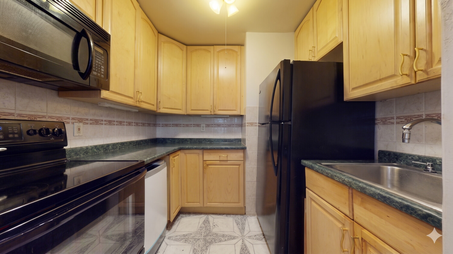1200 Gravesend Neck Road, Unit 3L Brooklyn, NY 11229 - Photo 9 of 10 a kitchen with granite countertop stainless steel appliances and cabinets
