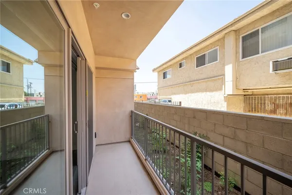 a view of balcony with wooden floor and brick walls