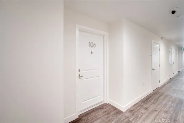 a view of a hallway with wooden floor