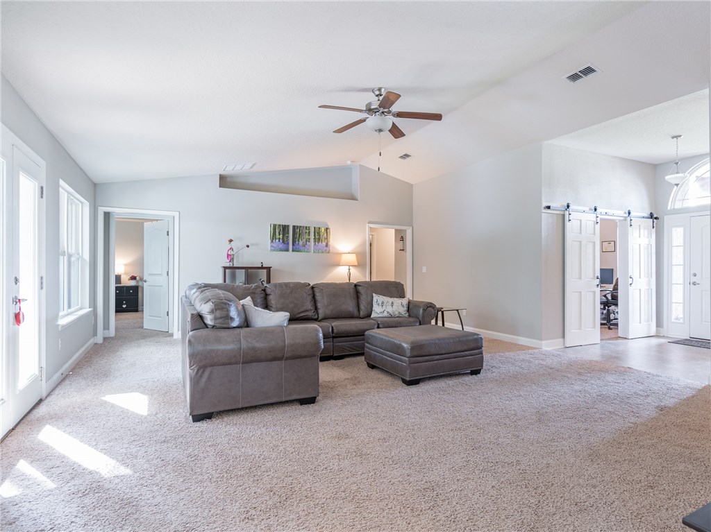 88007 Maybourne Road Yulee, FL 32097 - Photo 12 of 35 a living room with furniture and a chandelier