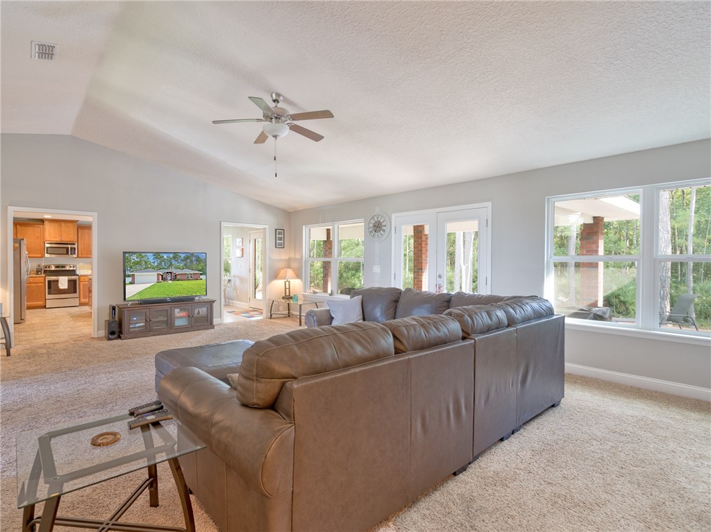 88007 Maybourne Road Yulee, FL 32097 - Photo 14 of 35 a living room with furniture and a flat screen tv
