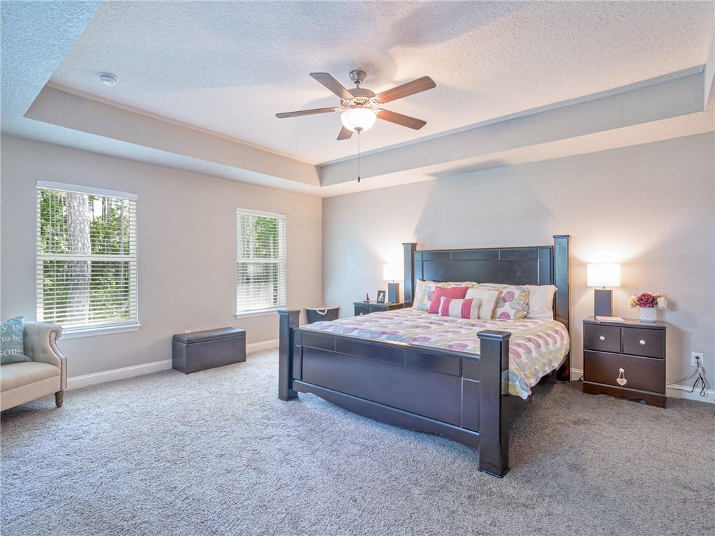 88007 Maybourne Road Yulee, FL 32097 - Photo 18 of 35 a spacious bedroom with a bed and a window