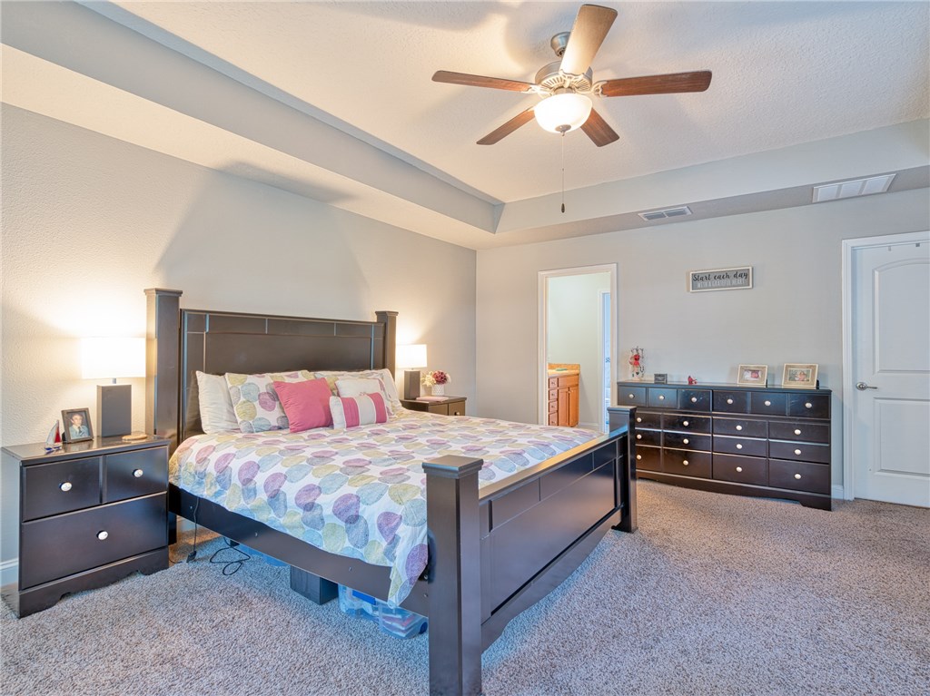 88007 Maybourne Road Yulee, FL 32097 - Photo 19 of 35 a bedroom with a bed and a chandelier