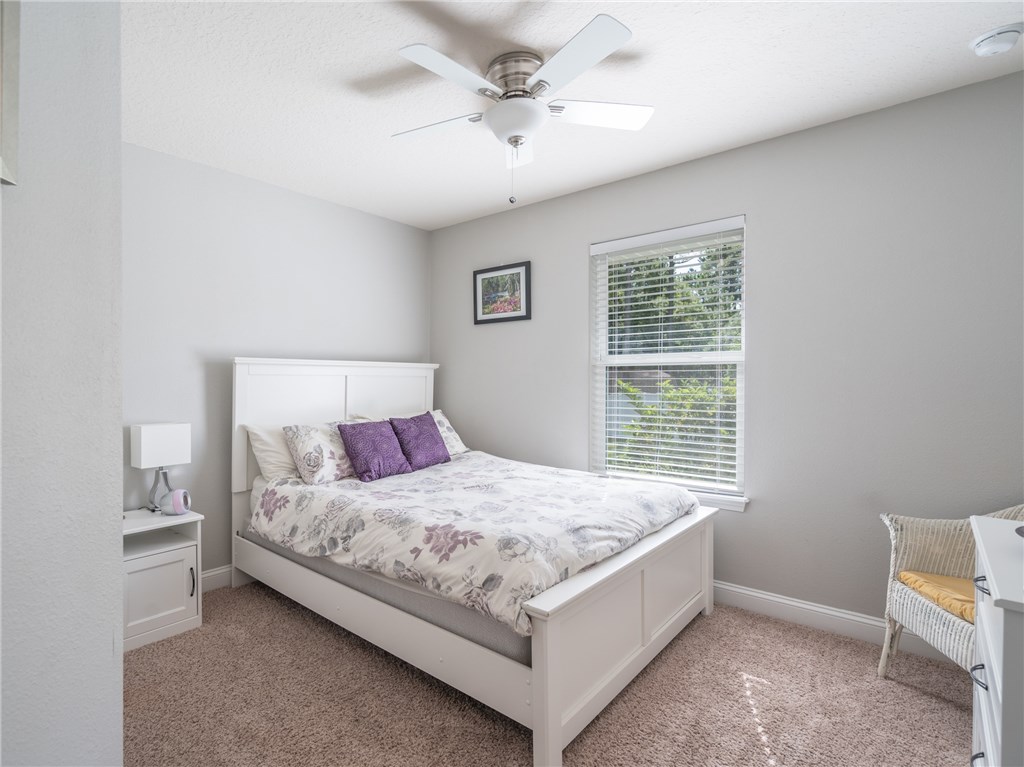 88007 Maybourne Road Yulee, FL 32097 - Photo 22 of 35 a bedroom with a bed and a window