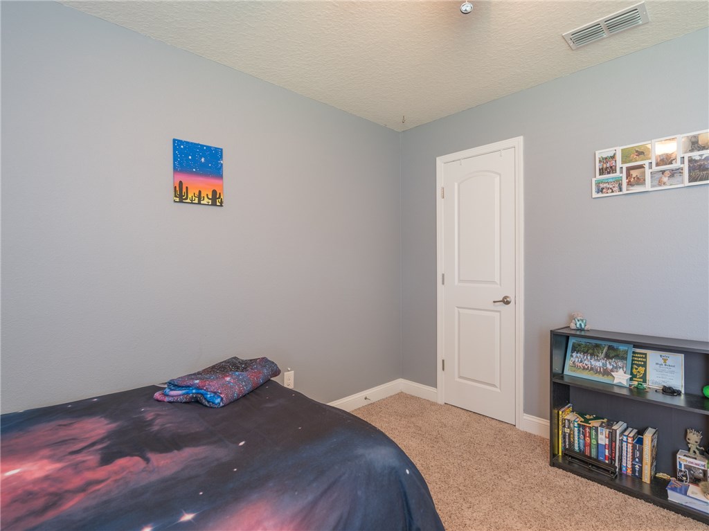 88007 Maybourne Road Yulee, FL 32097 - Photo 27 of 35 a bedroom with a bed and a book shelf