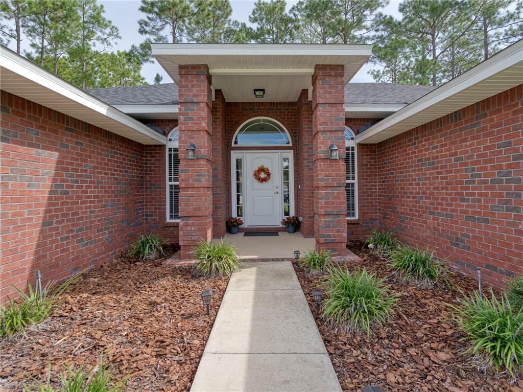 88007 Maybourne Road Yulee, FL 32097 - Photo 3 of 35 a front view of a house with garden