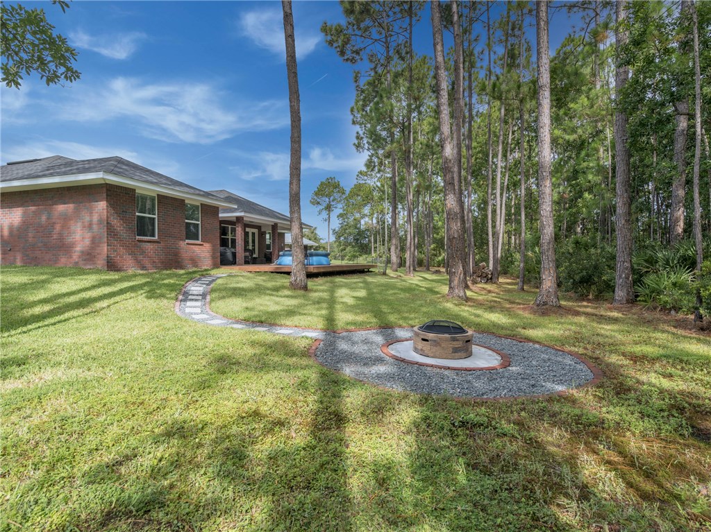 88007 Maybourne Road Yulee, FL 32097 - Photo 35 of 35 a backyard of a house with yard and outdoor seating