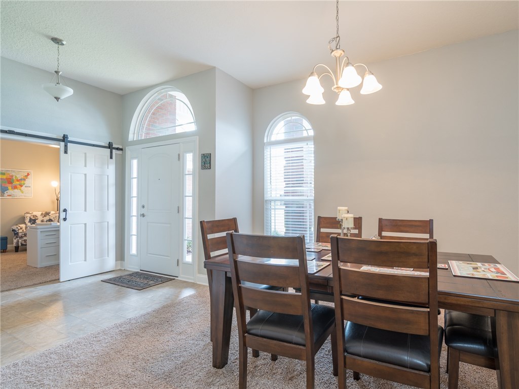 88007 Maybourne Road Yulee, FL 32097 - Photo 8 of 35 a view of a dining room with furniture and a chandelier