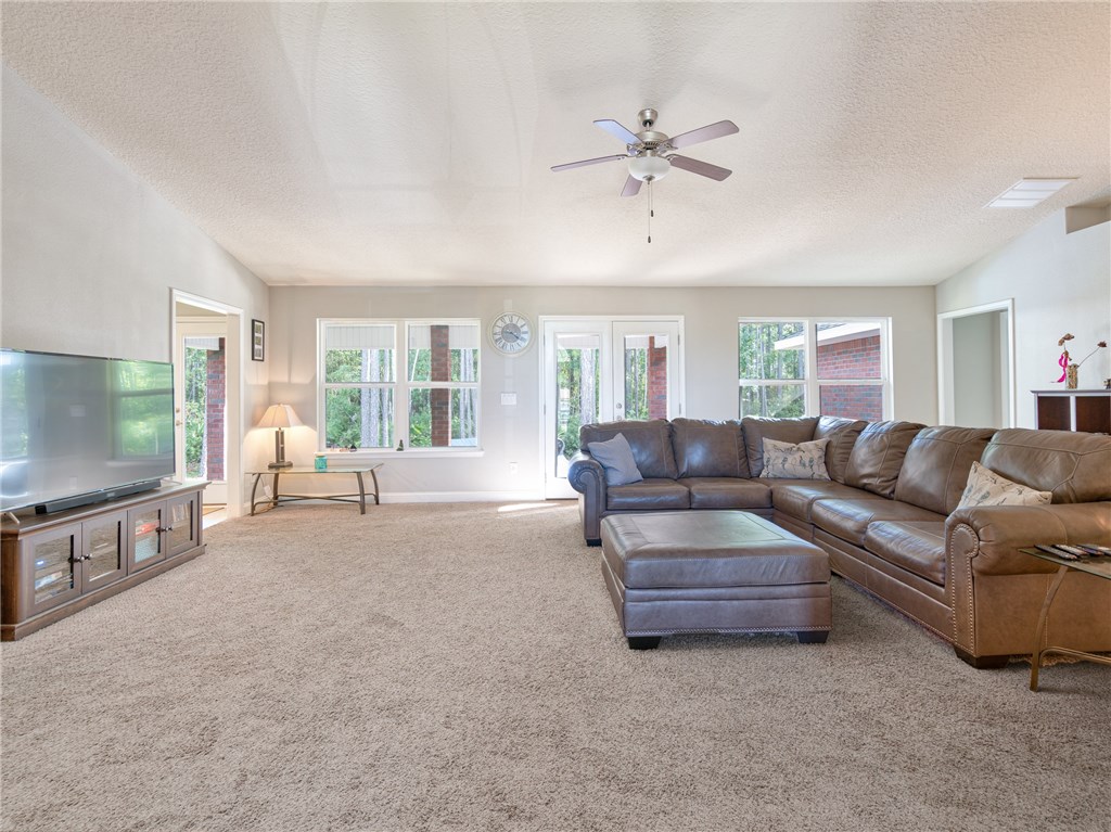 88007 Maybourne Road Yulee, FL 32097 - Photo 10 of 35 a living room with furniture and a flat screen tv