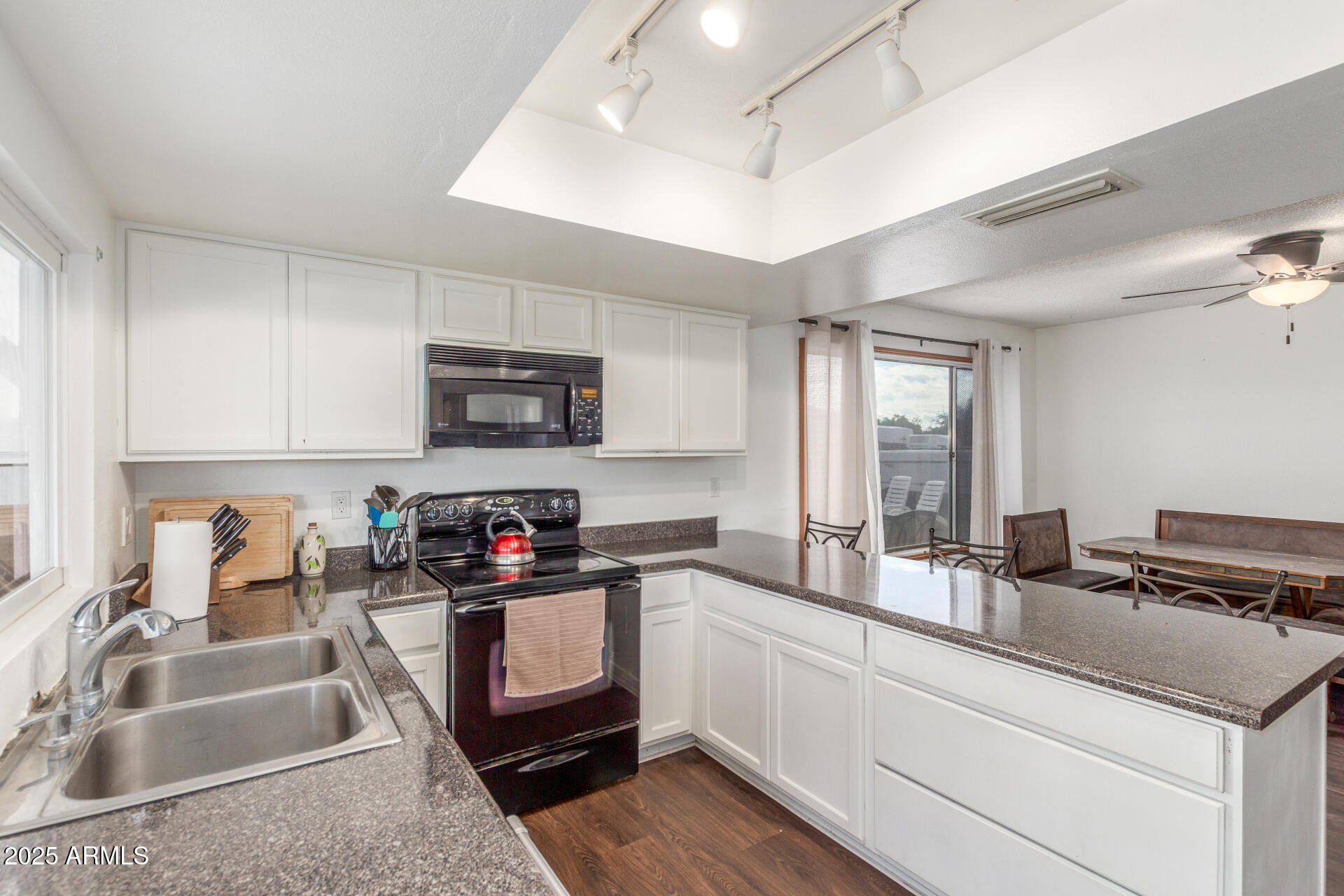4732 West Davis Road Glendale, AZ 85306 - Photo 13 of 38 a kitchen with granite countertop a sink and a stove top oven