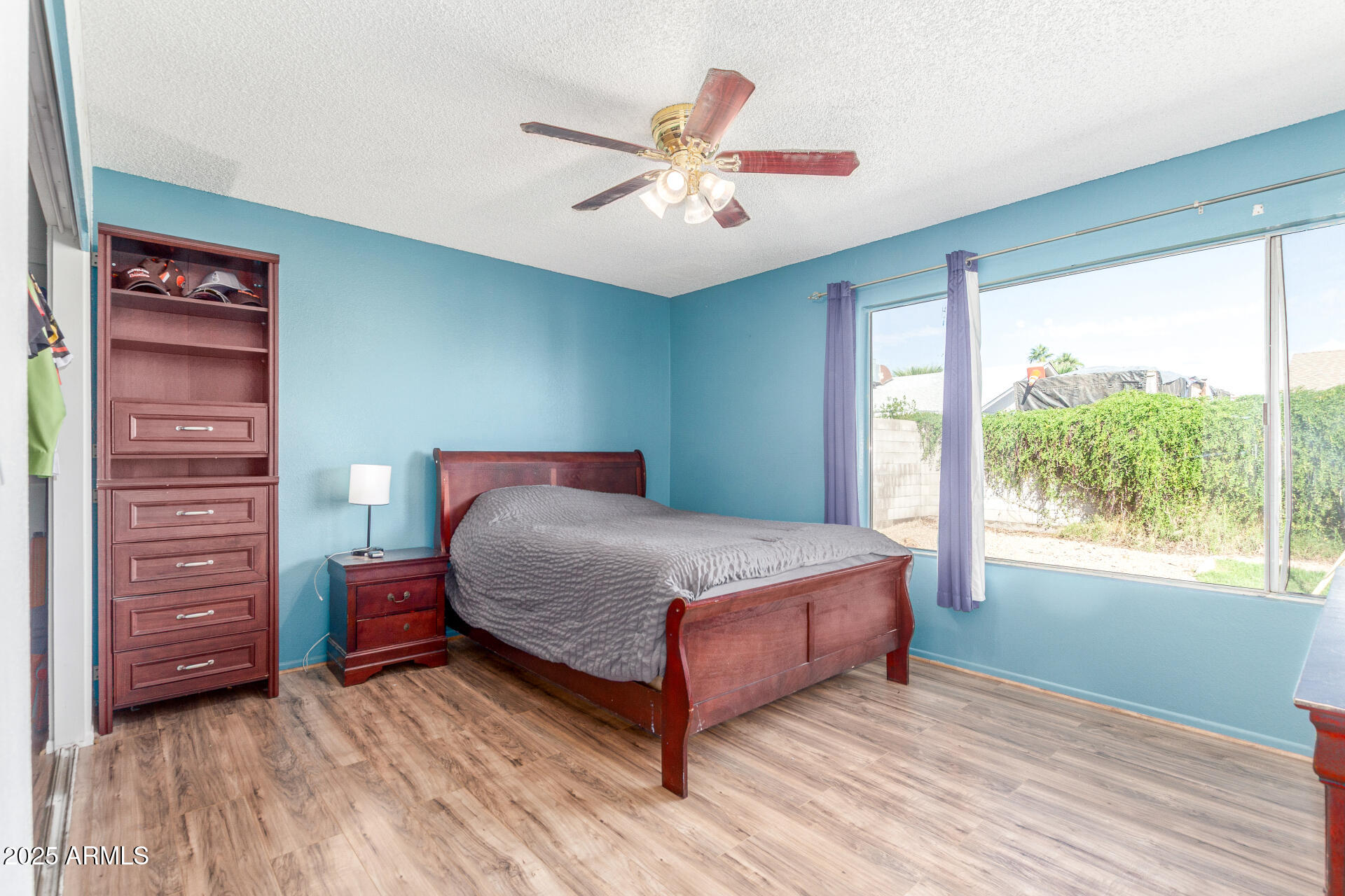 4732 West Davis Road Glendale, AZ 85306 - Photo 14 of 38 a bedroom with a bed and a large window
