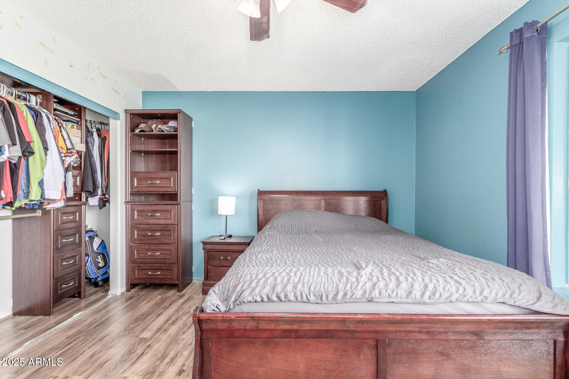 4732 West Davis Road Glendale, AZ 85306 - Photo 15 of 38 a bedroom with a bed and a closet