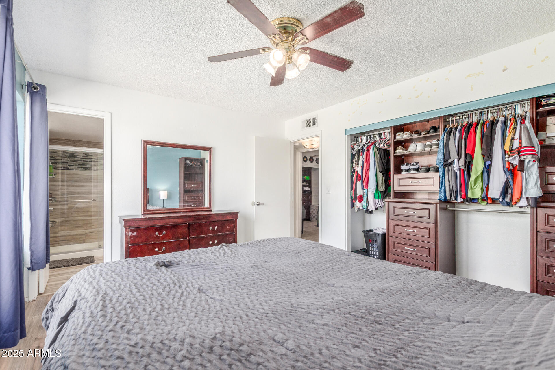 4732 West Davis Road Glendale, AZ 85306 - Photo 16 of 38 a bedroom with a bed and a chandelier