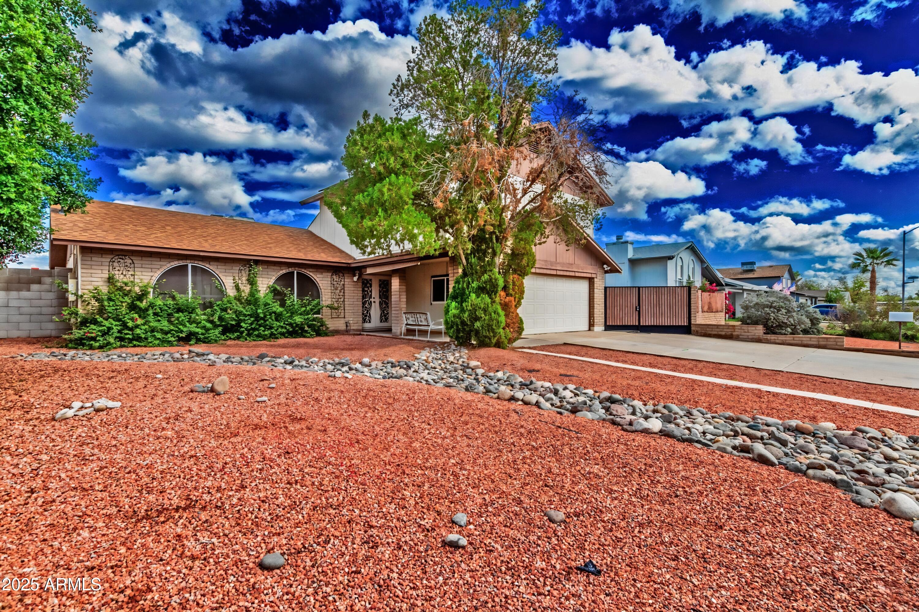 4732 West Davis Road Glendale, AZ 85306 - Photo 3 of 38 a front view of a house with a yard