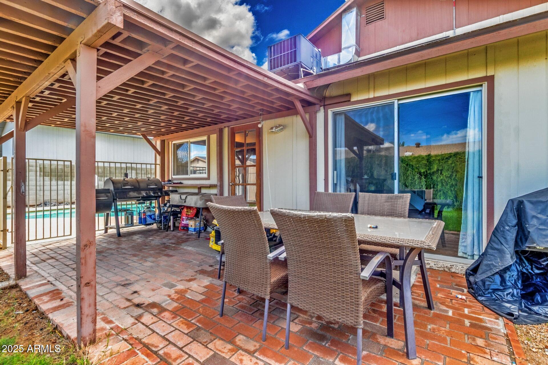 4732 West Davis Road Glendale, AZ 85306 - Photo 33 of 38 a view of a patio with a table and chairs and potted plants