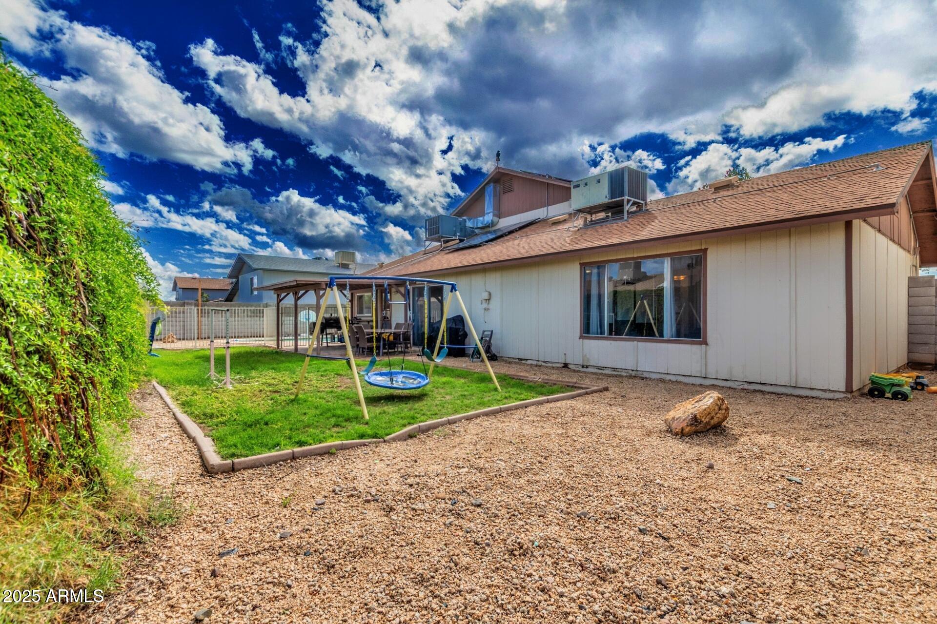 4732 West Davis Road Glendale, AZ 85306 - Photo 34 of 38 a backyard of a house with barbeque oven table and chairs