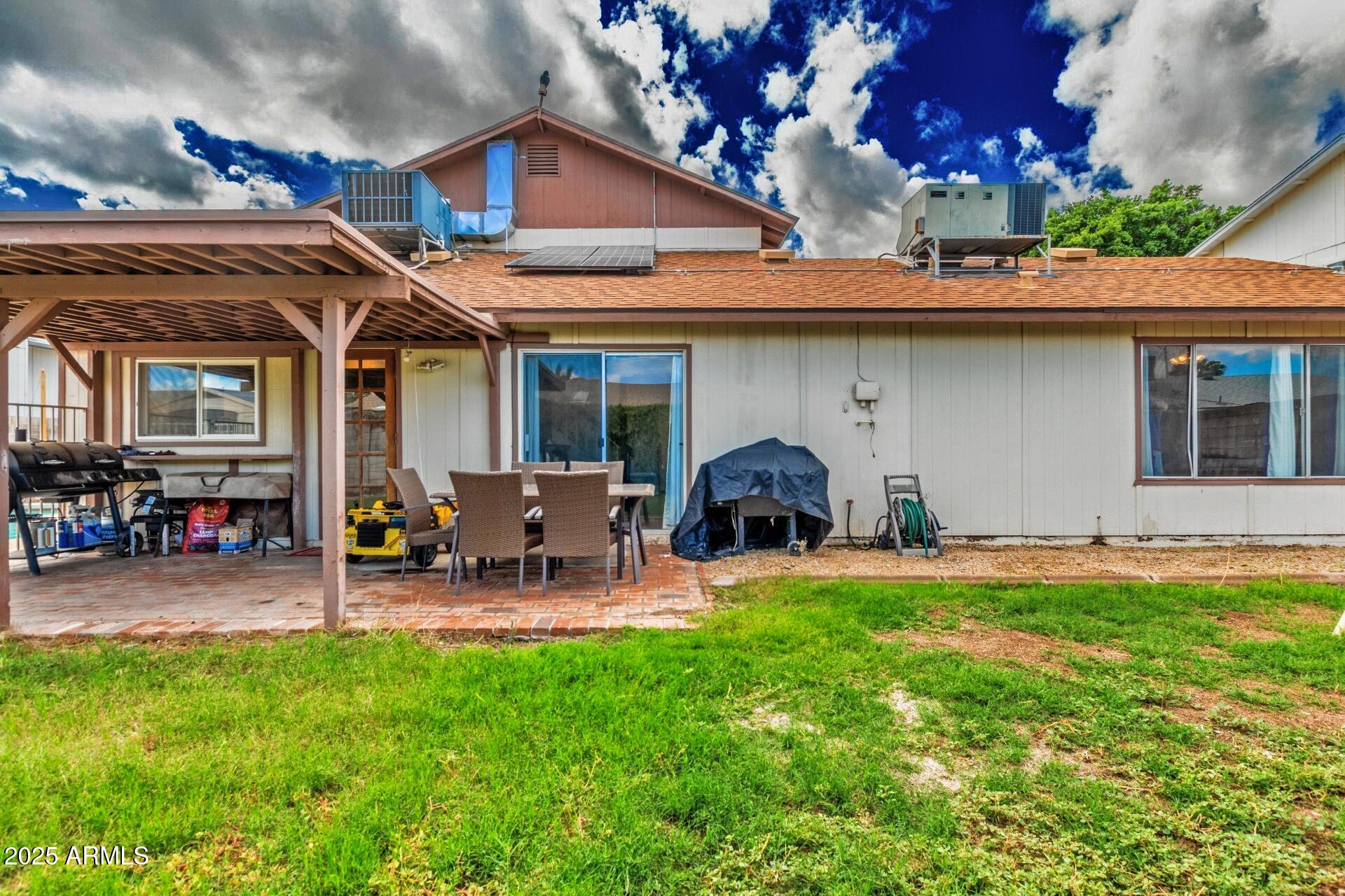 4732 West Davis Road Glendale, AZ 85306 - Photo 35 of 38 a backyard of a house with table and chairs