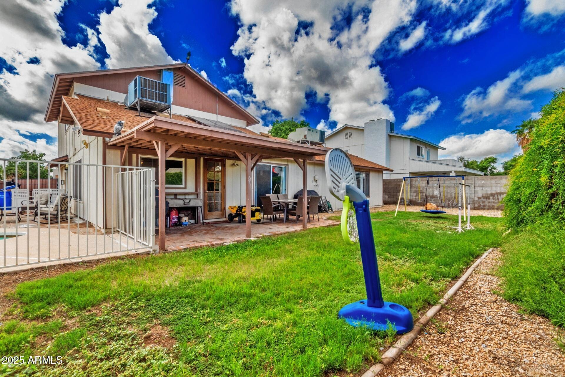 4732 West Davis Road Glendale, AZ 85306 - Photo 36 of 38 a view of a house with a backyard porch and sitting area