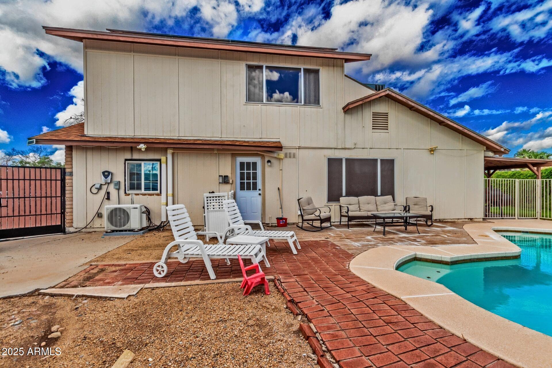 4732 West Davis Road Glendale, AZ 85306 - Photo 37 of 38 a view of a house with backyard sitting area and furniture