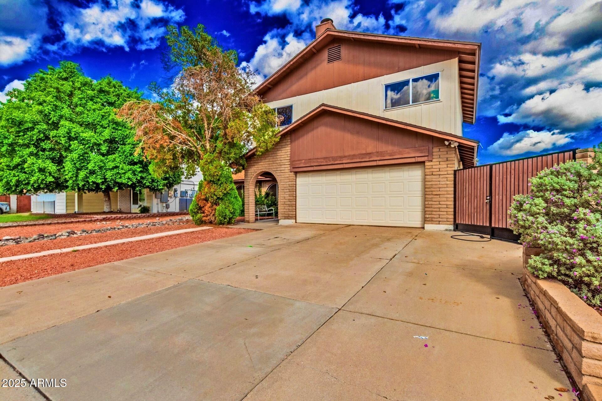 4732 West Davis Road Glendale, AZ 85306 - Photo 5 of 38 a view of a house with a yard and garage