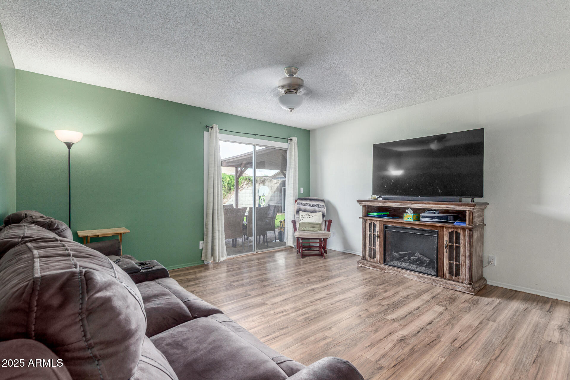 4732 West Davis Road Glendale, AZ 85306 - Photo 7 of 38 a living room with furniture and a flat screen tv