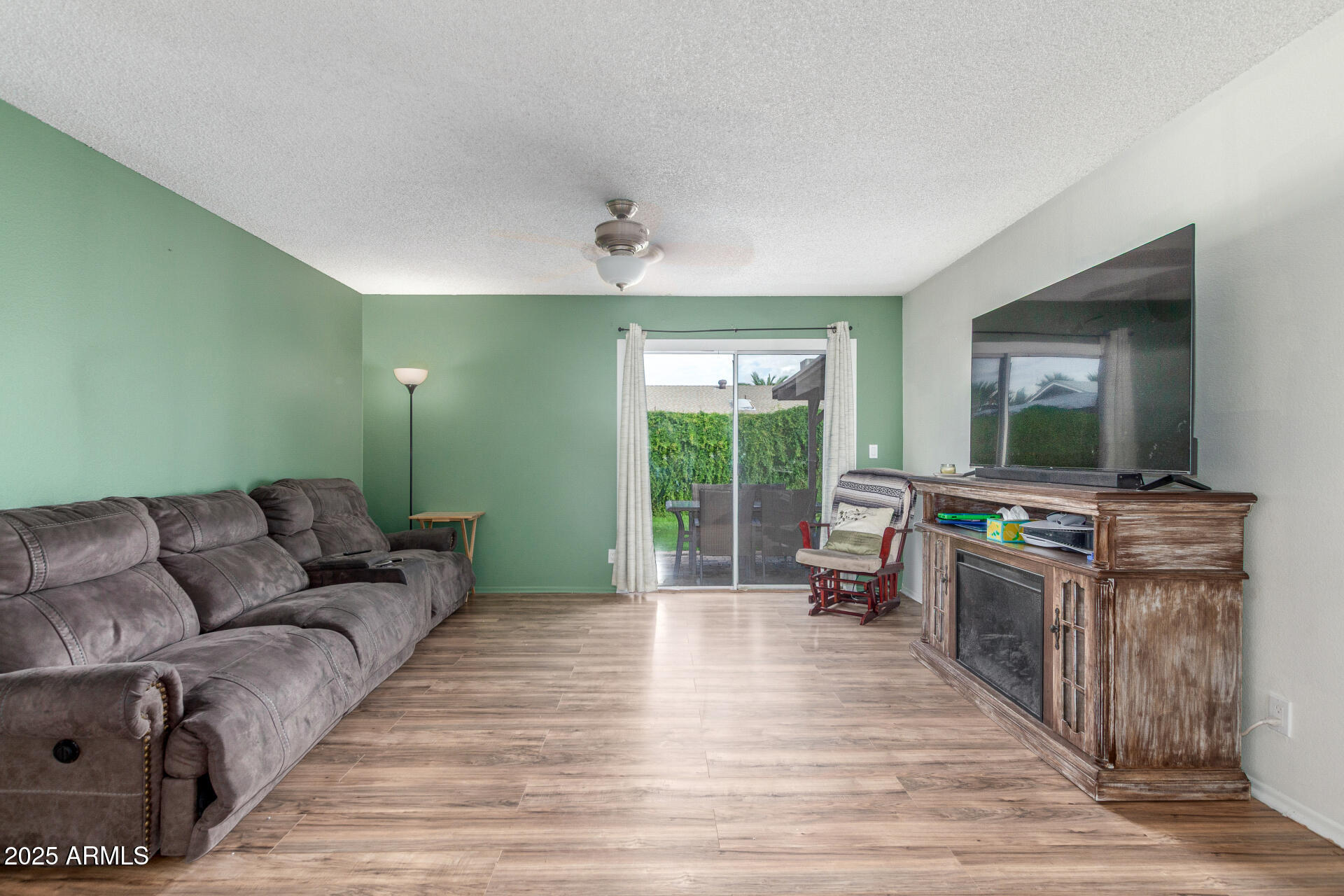 4732 West Davis Road Glendale, AZ 85306 - Photo 8 of 38 a living room with furniture and a flat screen tv
