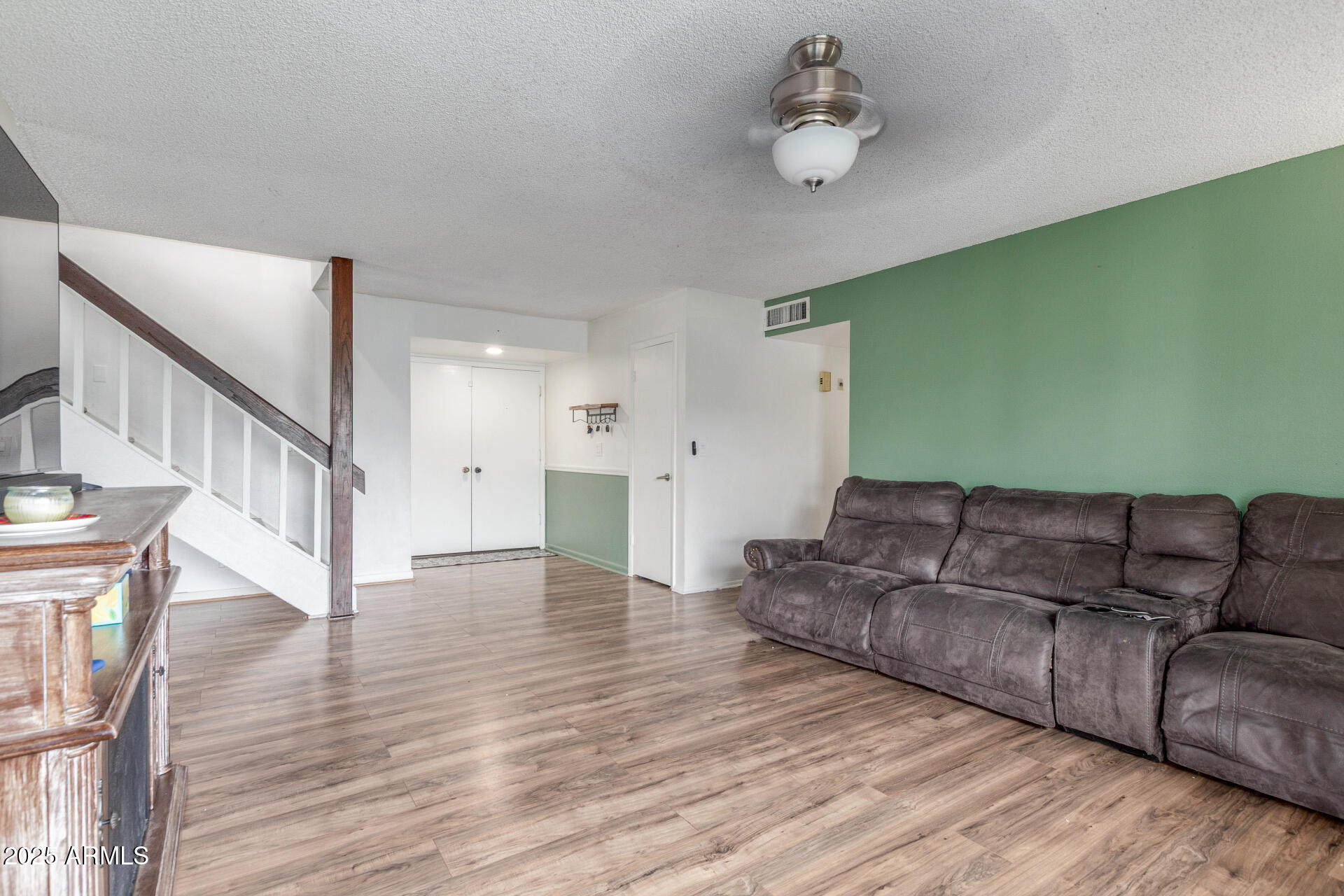 4732 West Davis Road Glendale, AZ 85306 - Photo 9 of 38 a living room with furniture and a wooden floor