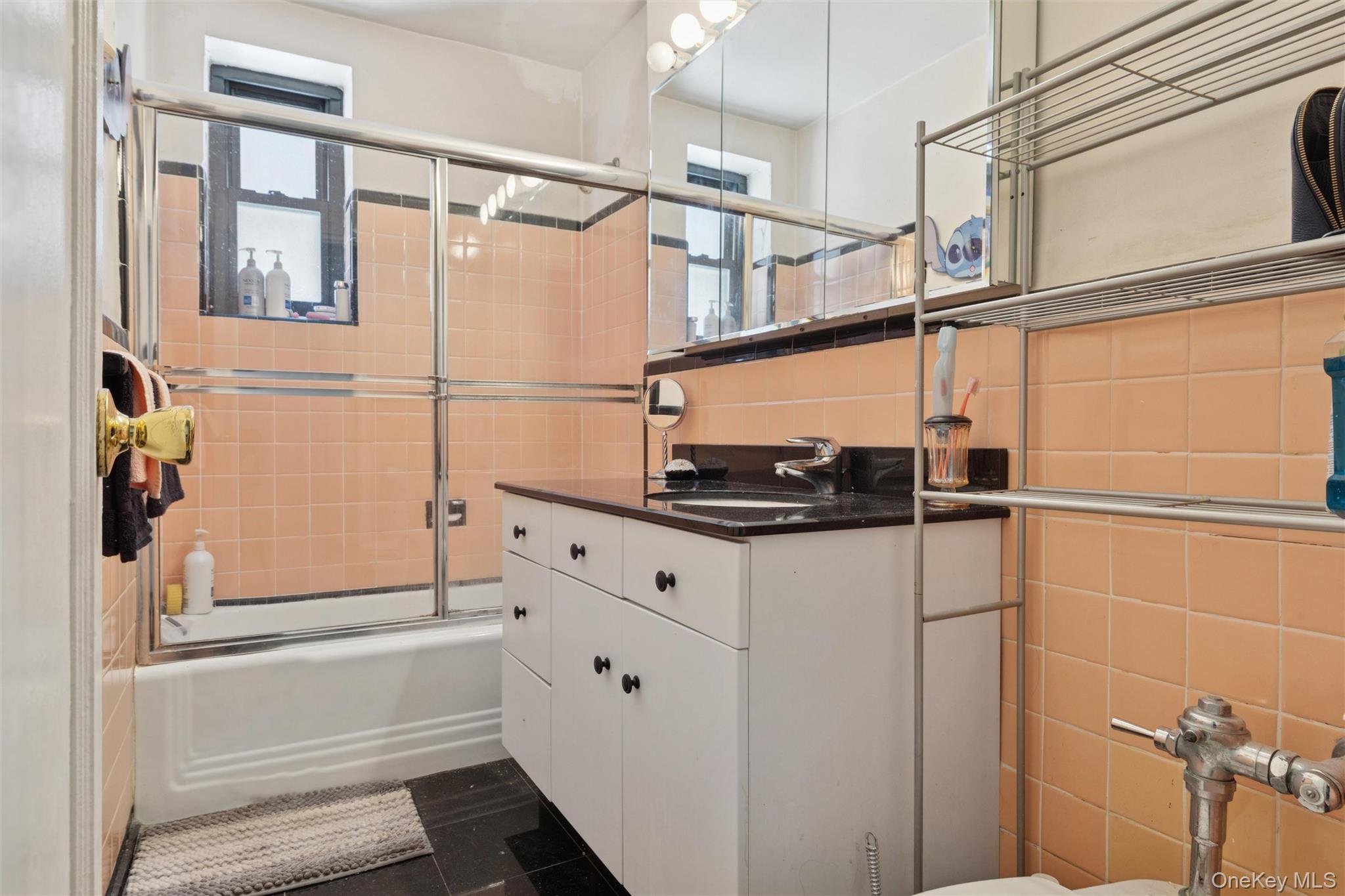 32-40 92nd Street, Unit 107 Queens, NY 11369 - Photo 11 of 16 a bathroom with a shower and a sink