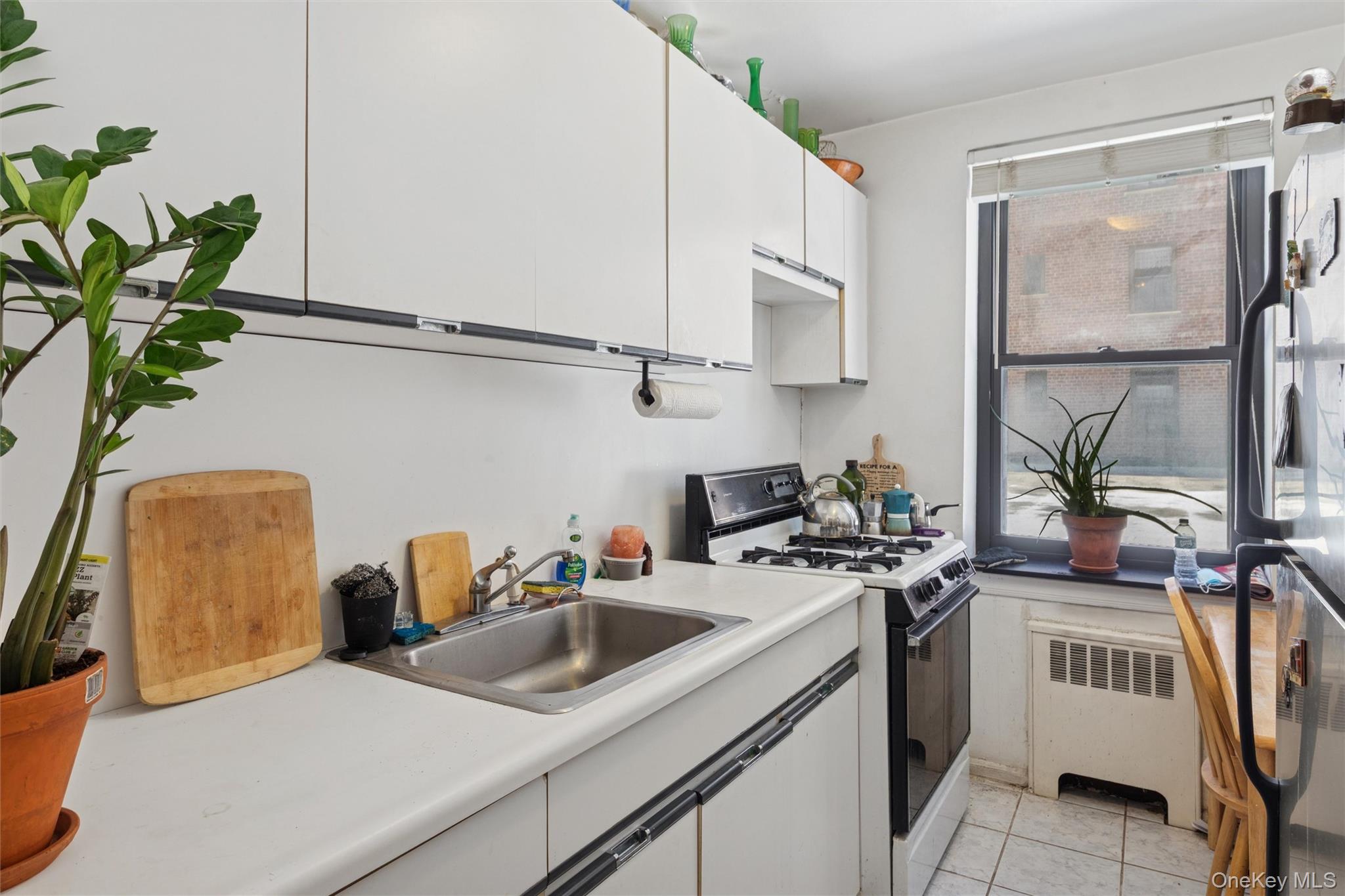 32-40 92nd Street, Unit 107 Queens, NY 11369 - Photo 2 of 16 a view of a kitchen with sink and stove