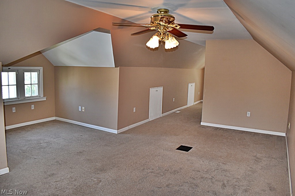 7715 Ackley Road Parma, OH 44129 - Photo 17 of 27 Primary bedroom featuring carpet flooring, vaulted ceiling, and ceiling fan